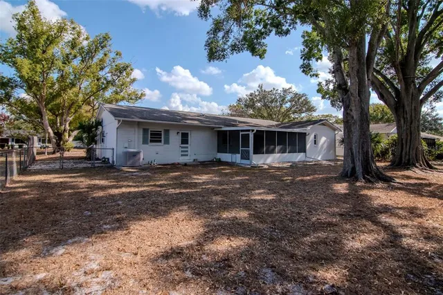 a view of a house with a backyard