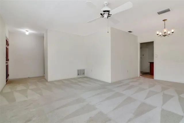 a view of empty room with a ceiling fan