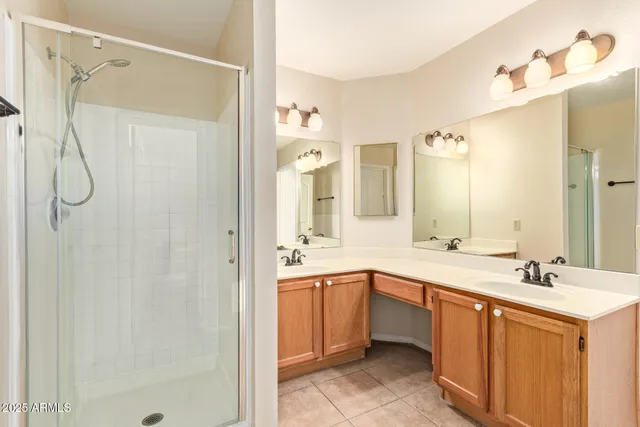a bathroom with a double vanity sink a mirror a shower and a bathtub