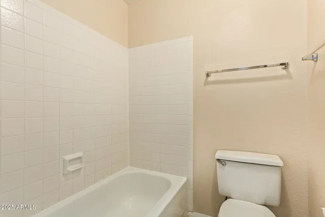 a bathroom with a toilet and bathtub