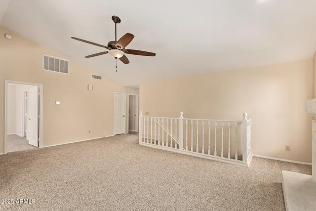 a view of a livingroom with a ceiling fan and window