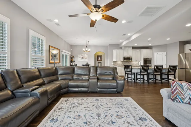 a living room with furniture wooden floor and a rug