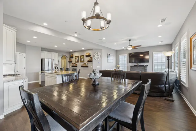 a dining room with stainless steel appliances furniture dining table and chairs