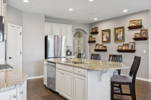 a kitchen with refrigerator and cabinets