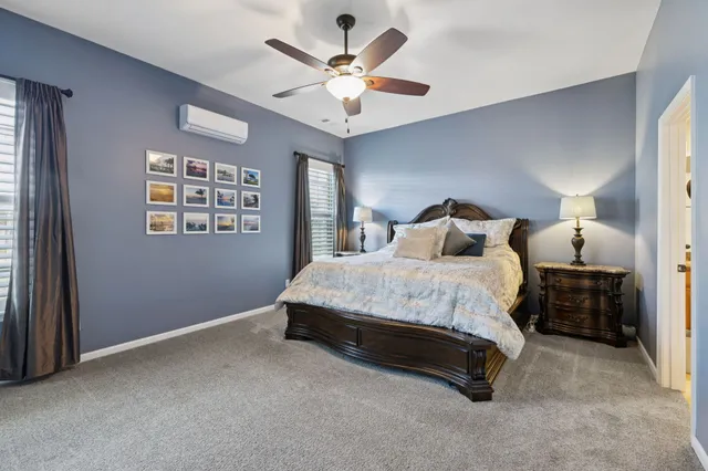 a spacious bedroom with a bed and a ceiling fan