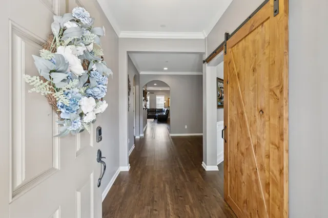 a view of a hallway view with wooden floor and staircase