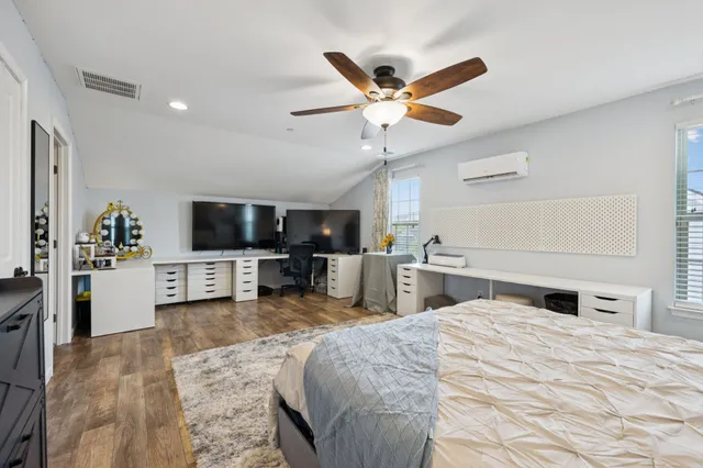 a bed room with a bed and a television