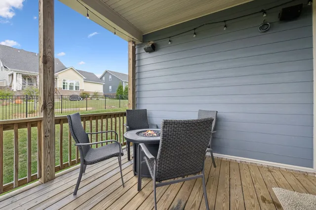 a balcony with table and chairs