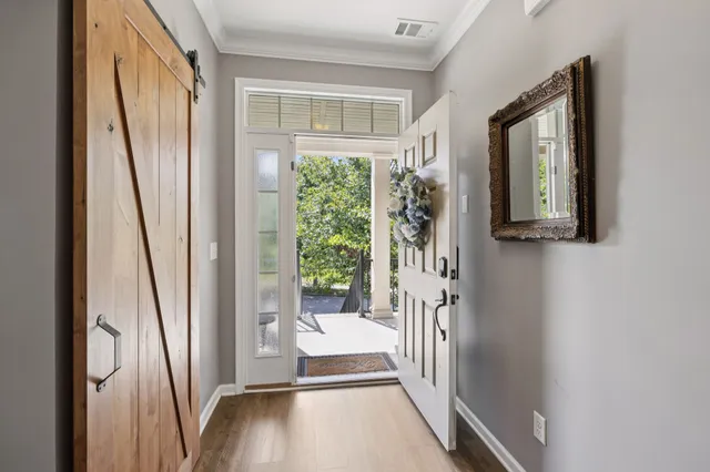 a view of front door with a potted plant and a window