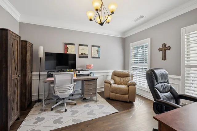 a view of a livingroom with workspace and a window