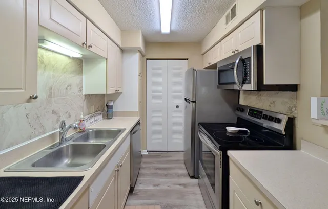 a kitchen that has a sink and a stove