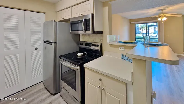 a kitchen with a sink appliances and cabinets