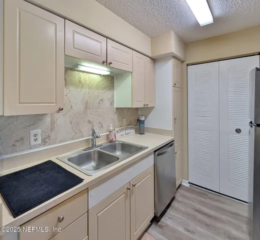 a kitchen with a sink and cabinets