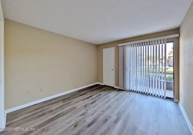a view of a room with wooden floor