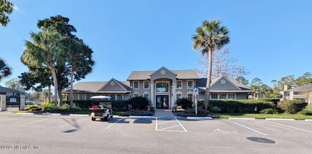 a view of a street with cars and palm trees
