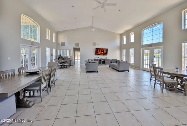 a living room with furniture and a dining table