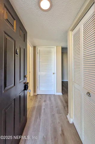a view of a room with wooden floor and window