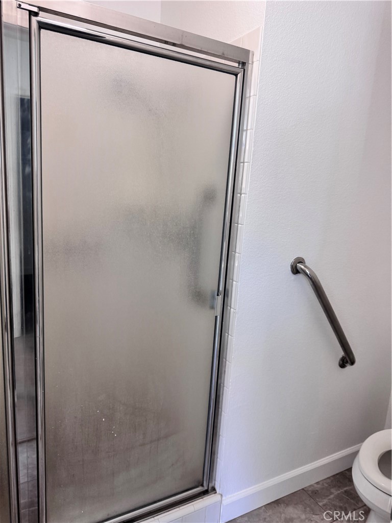 26226 Rainbow Glen Drive Newhall, CA 91321 - Photo 11 of 27 a bathroom with a glass shower door