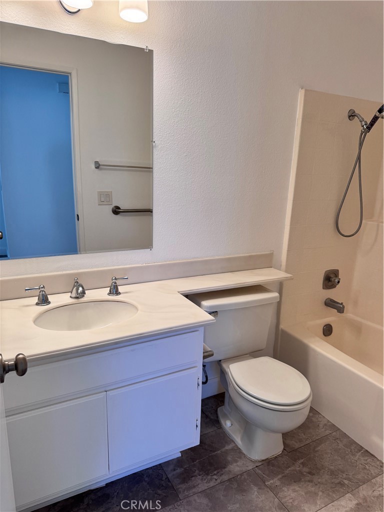 26226 Rainbow Glen Drive Newhall, CA 91321 - Photo 14 of 27 a bathroom with a toilet a sink and a bathtub