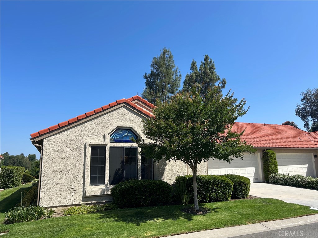 26226 Rainbow Glen Drive Newhall, CA 91321 - Photo 2 of 27 a front view of a house with a yard