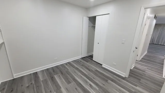 a view of room with wooden floor