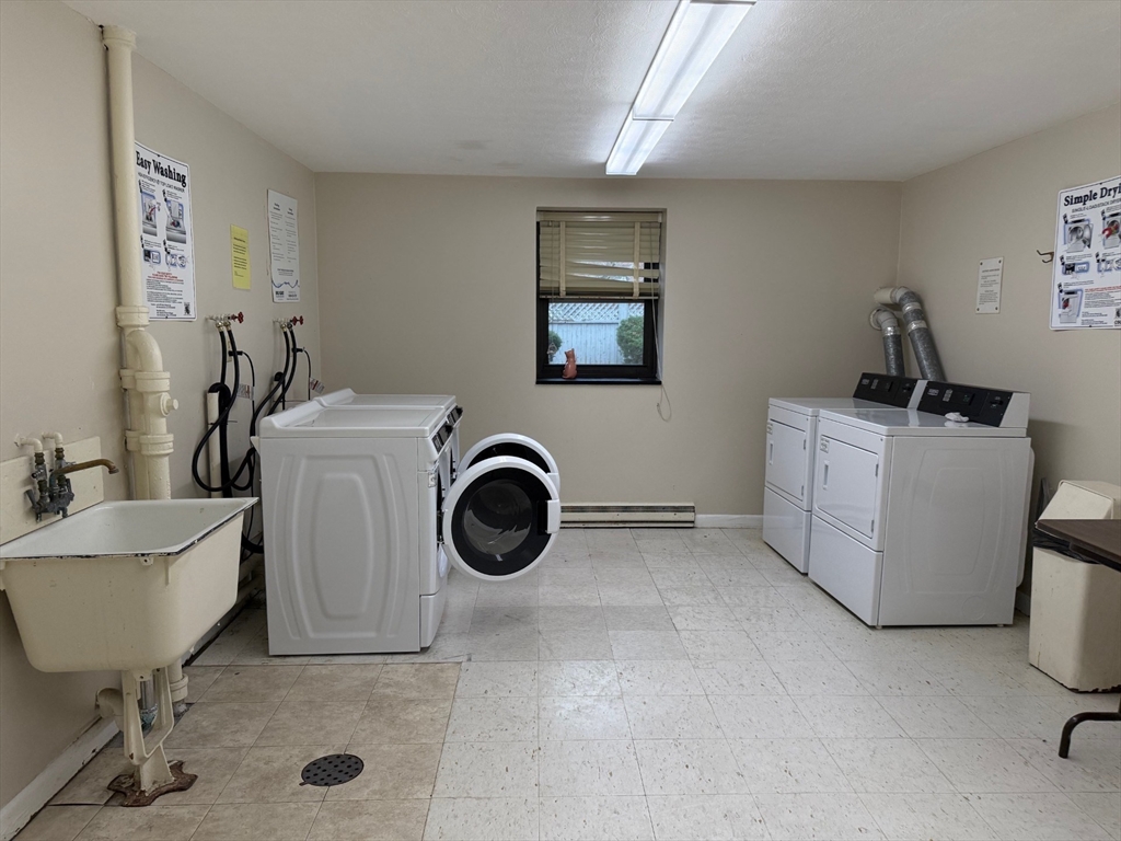 1325 Worcester Road, Unit D8 Framingham, MA 01701 - Photo 17 of 20 a utility room with dryer and washer