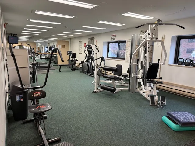 a room with gym equipment and windows