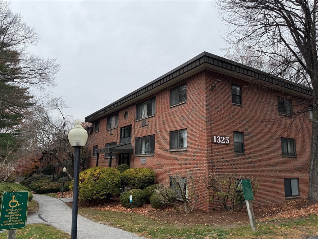 1325 Worcester Road, Unit D8 Framingham, MA 01701 - Photo 2 of 20 a front view of a house with garden