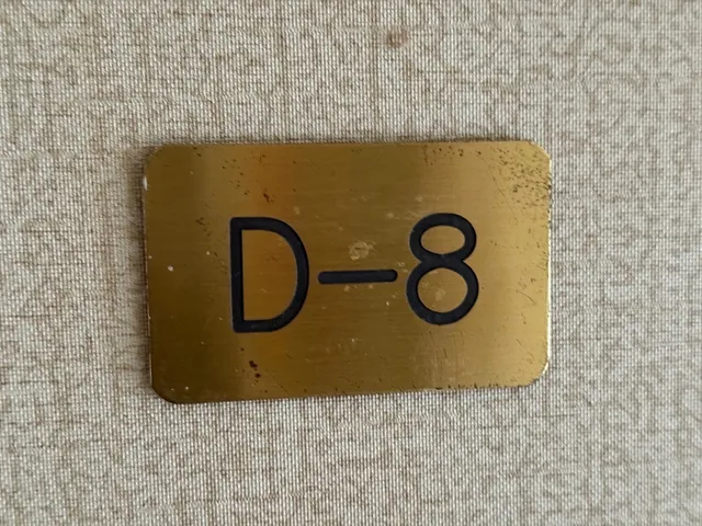 an empty room with wooden floor cabinet and windows