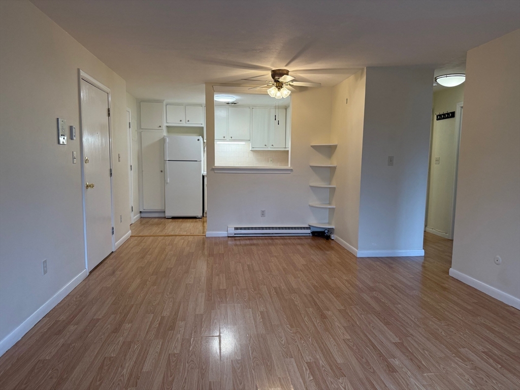 1325 Worcester Road, Unit D8 Framingham, MA 01701 - Photo 6 of 20 an empty room with wooden floor and windows