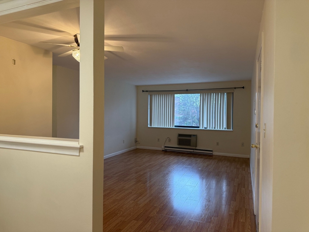 1325 Worcester Road, Unit D8 Framingham, MA 01701 - Photo 10 of 20 an empty room with wooden floor and windows