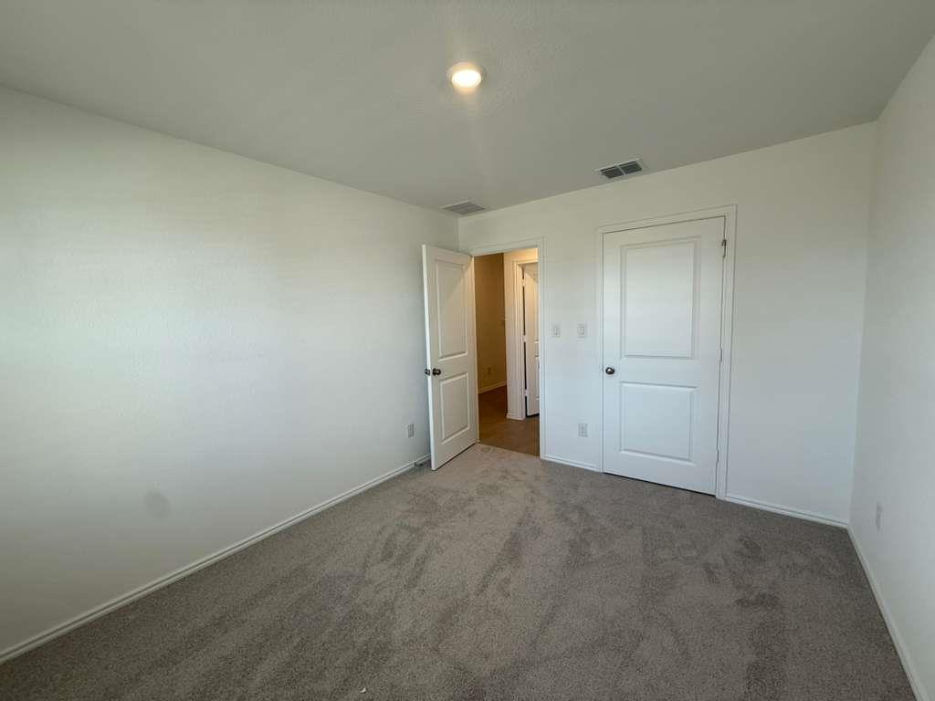 545 Sormonne Loop Kyle, TX 78640 - Photo 20 of 39 Unfurnished bedroom with carpet flooring and baseboards