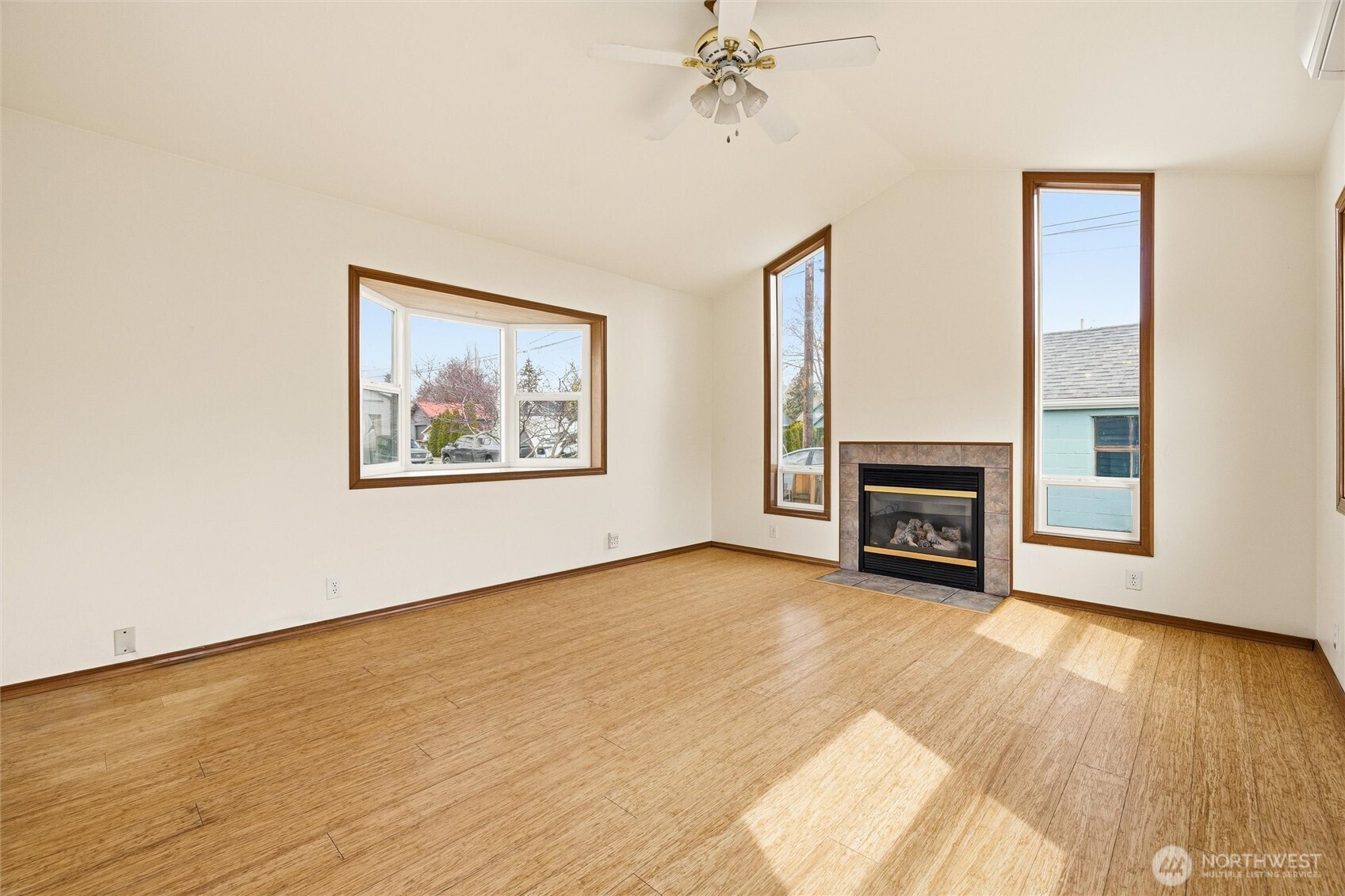 2836 Patton Street Bellingham, WA 98225 - Photo 14 of 40 a view of an empty room with wooden floor and a fireplace