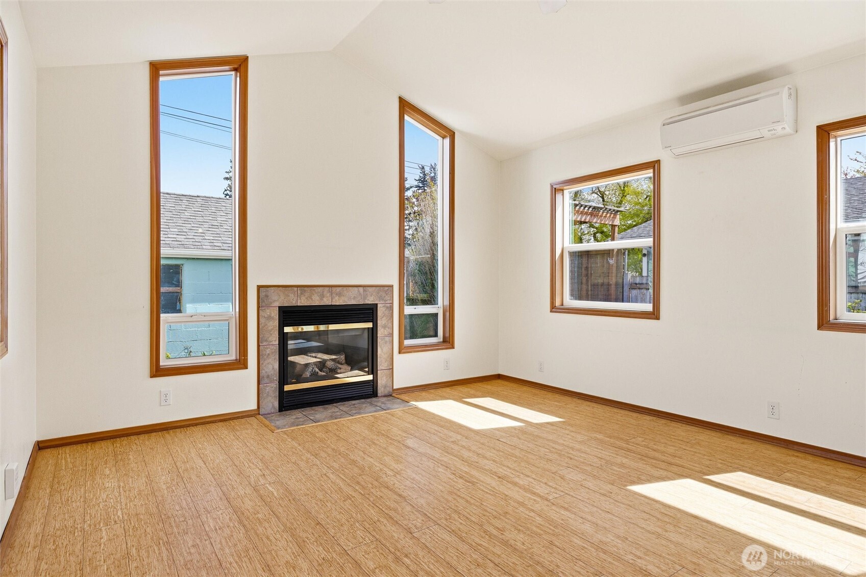 2836 Patton Street Bellingham, WA 98225 - Photo 15 of 40 an empty room with windows a fireplace and wooden floor