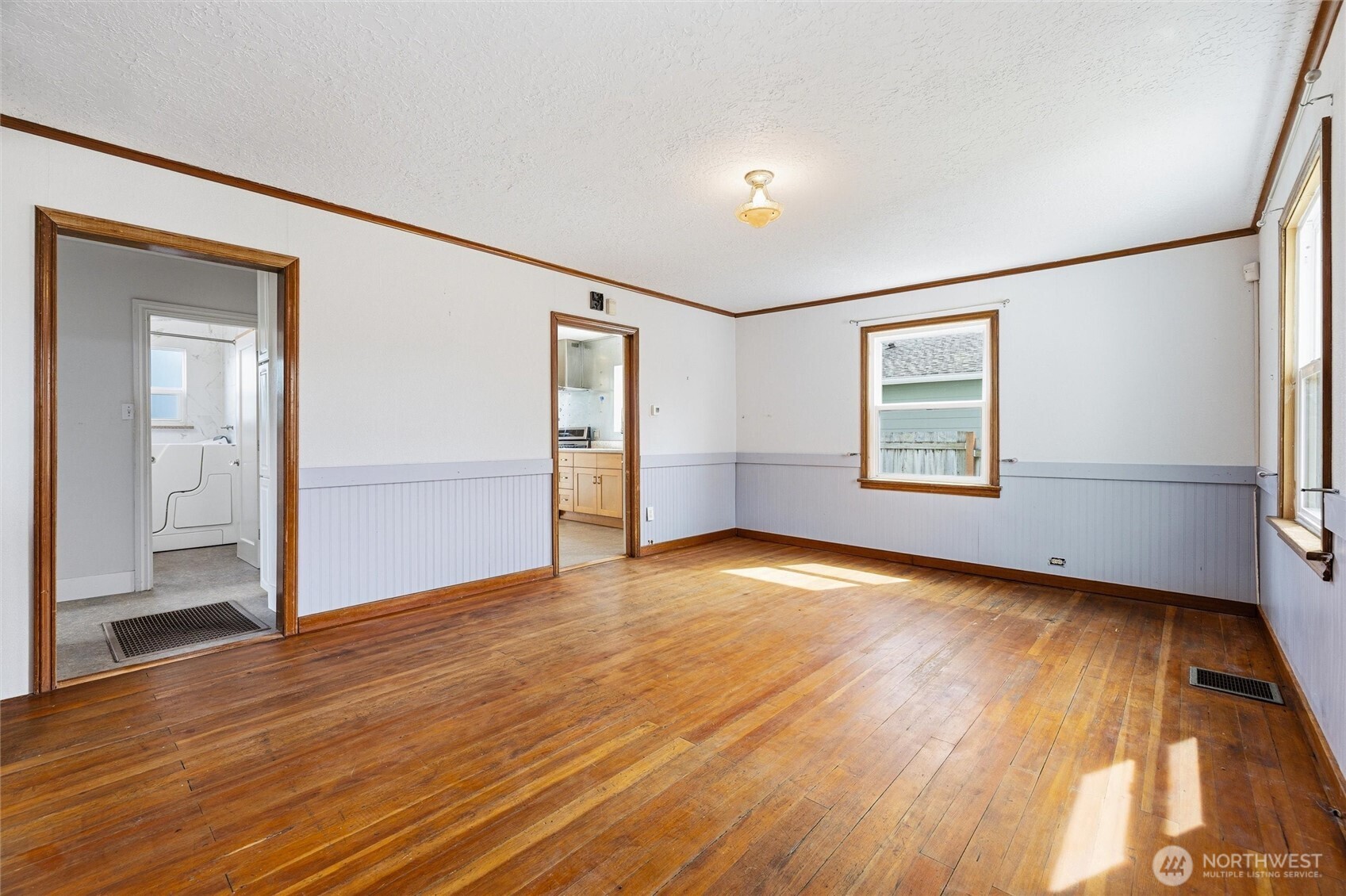 2836 Patton Street Bellingham, WA 98225 - Photo 6 of 40 an empty room with wooden floor cabinet and windows