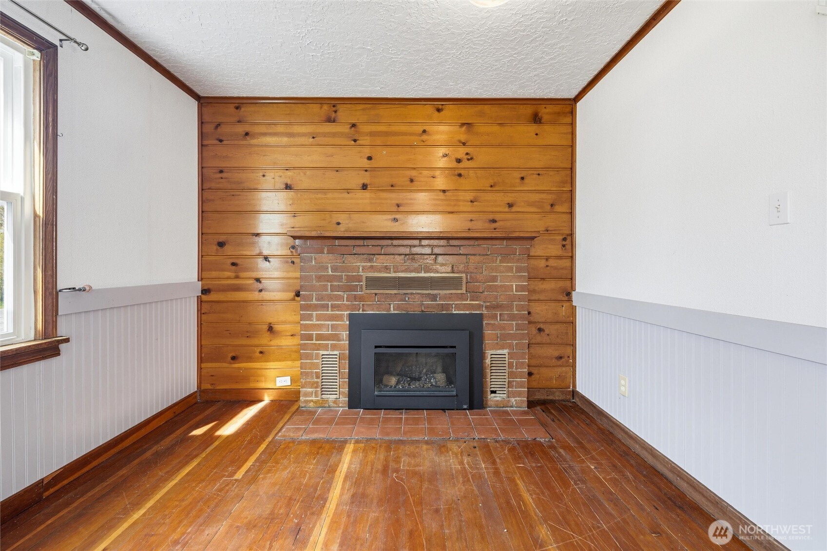 2836 Patton Street Bellingham, WA 98225 - Photo 7 of 40 a view of empty room with wooden floor and fireplace