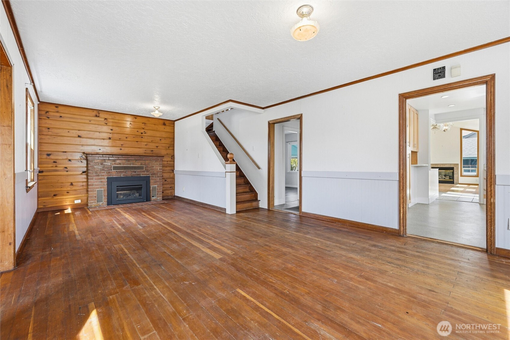 2836 Patton Street Bellingham, WA 98225 - Photo 8 of 40 a view of empty room with wooden floor and fireplace