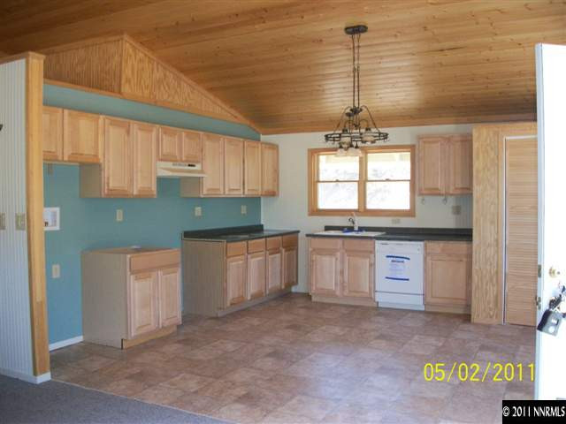 2830 Bullfrog Road Reno, NV 89521 - Photo 3 of 13 a kitchen with granite countertop white cabinets and window