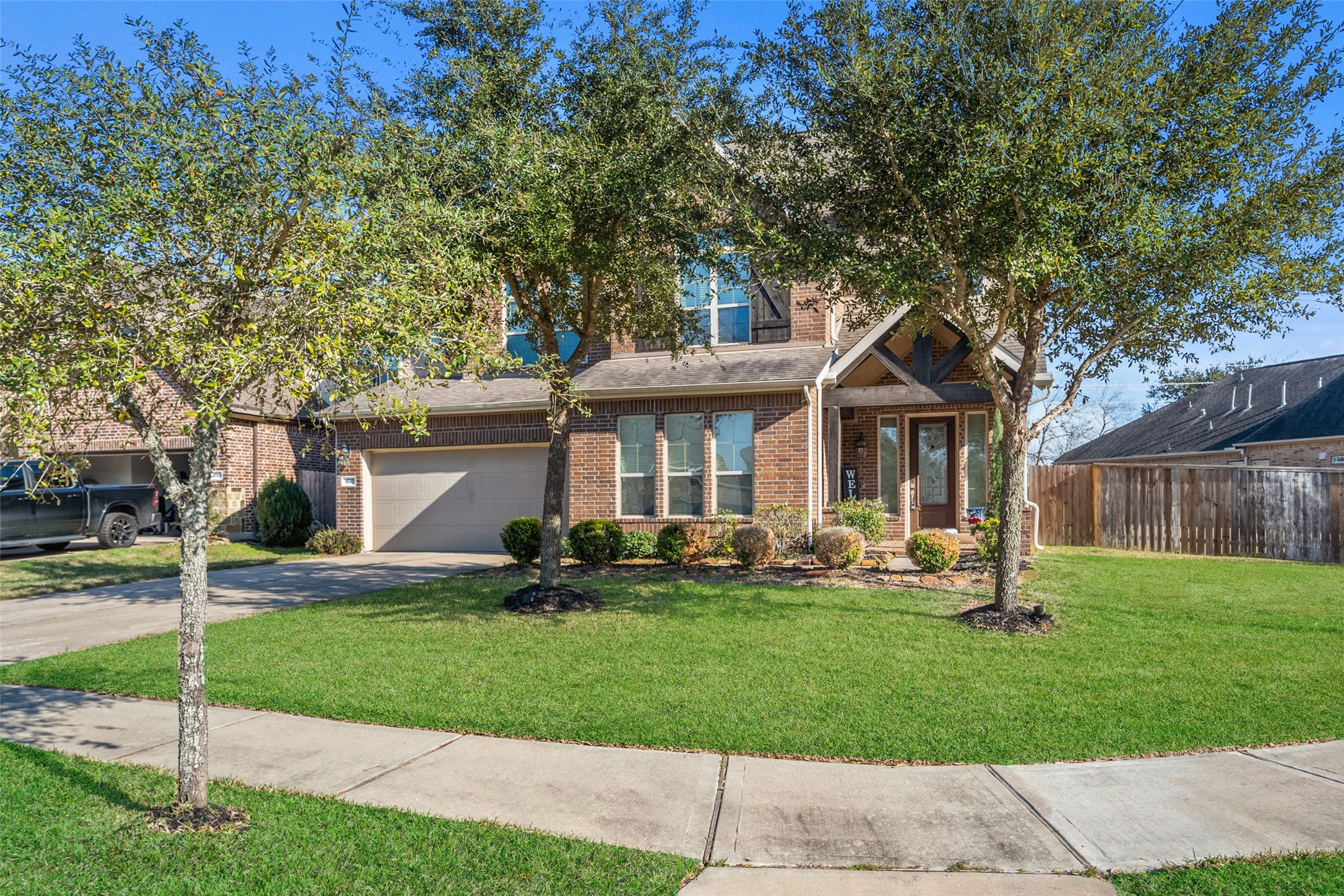 4747 Abercorn Street Rosharon, TX 77583 - Photo 46 of 46 This inviting two-story brick home features a well-maintained lawn, a two-car garage, and a charming front porch. Framed by mature trees and a tidy landscape, it offers great curb appeal in a suburban setting.
