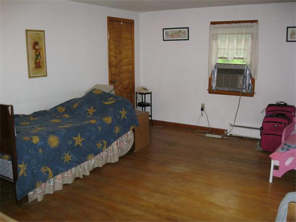 329 River Road Andover, MA 01810 - Photo 11 of 21 a bed sitting in a bedroom next to a window