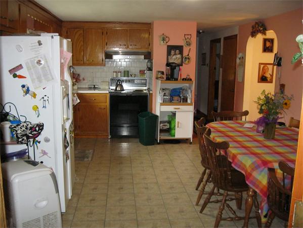 329 River Road Andover, MA 01810 - Photo 5 of 21 a kitchen with stainless steel appliances a refrigerator a sink a stove and white cabinets