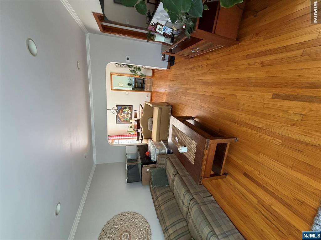 734 Clark Avenue Ridgefield, NJ 07657 - Photo 6 of 12 a living room with furniture and a wooden floor