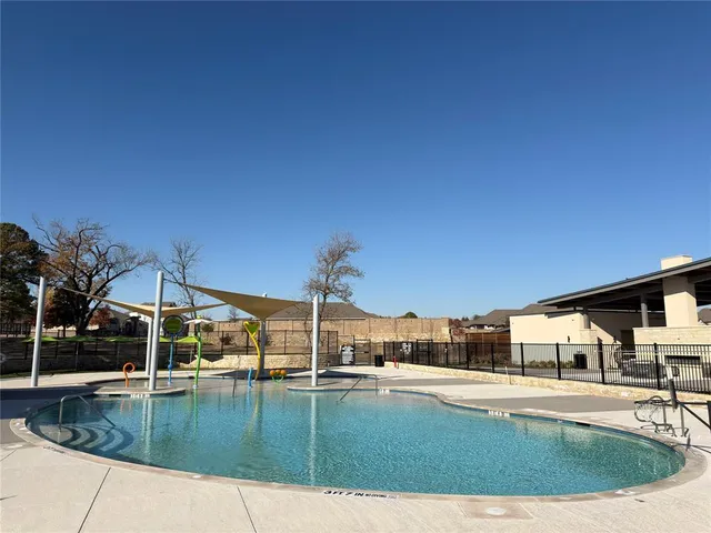 a view of swimming pool with a yard