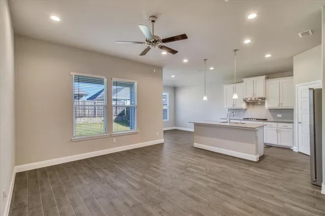 a view of kitchen with sink and wooden floor