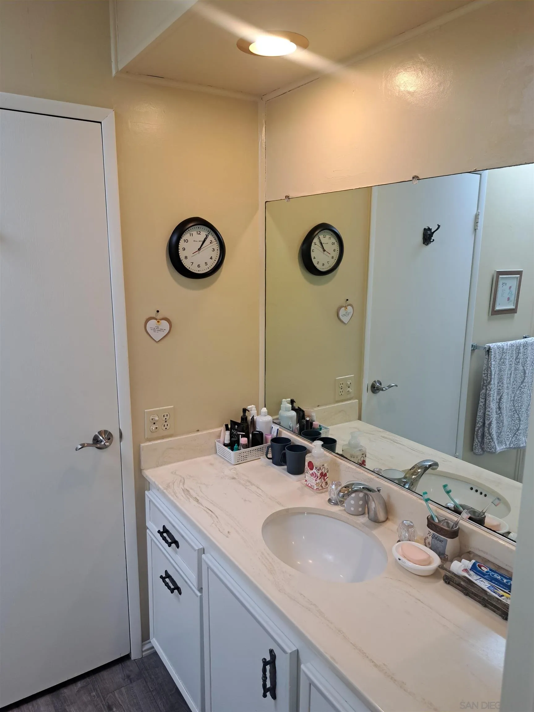 4650 Dulin Road, Unit 12 Fallbrook, CA 92003 - Photo 23 of 36 a bathroom with a granite countertop sink and a mirror