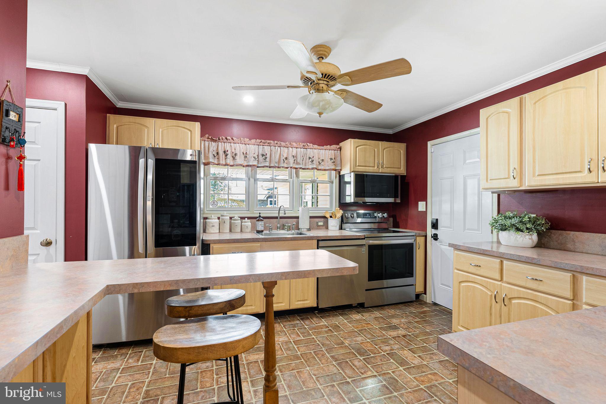48 Silverbell Road Levittown, PA 19056 - Photo 13 of 35 a large kitchen with stainless steel appliances a stove a sink and a refrigerator