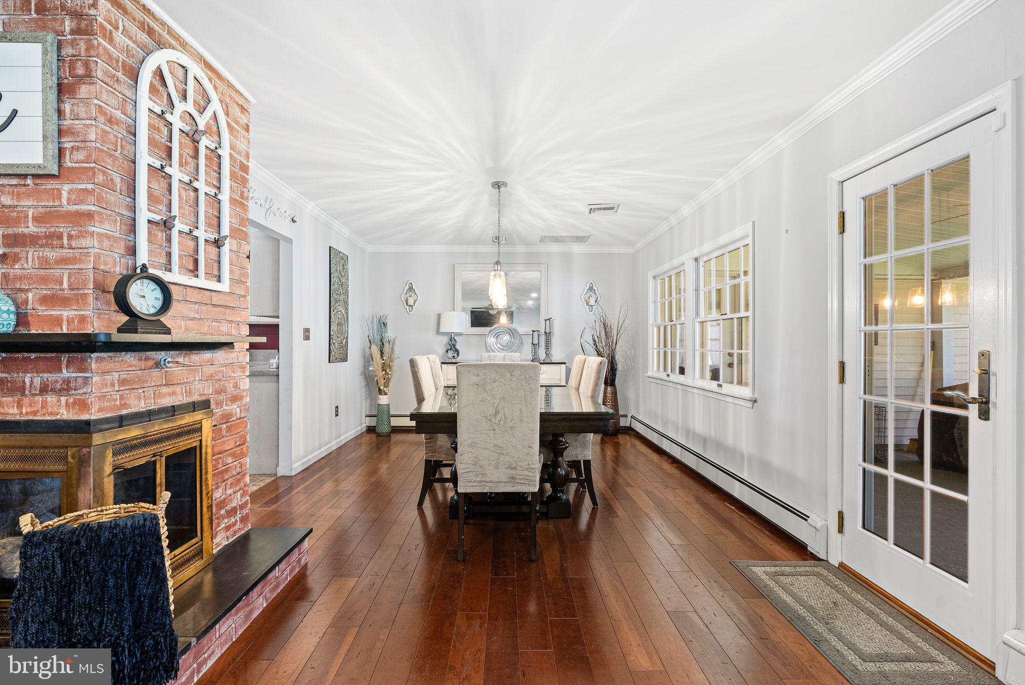 48 Silverbell Road Levittown, PA 19056 - Photo 10 of 35 a dining room with furniture a fireplace and wooden floor