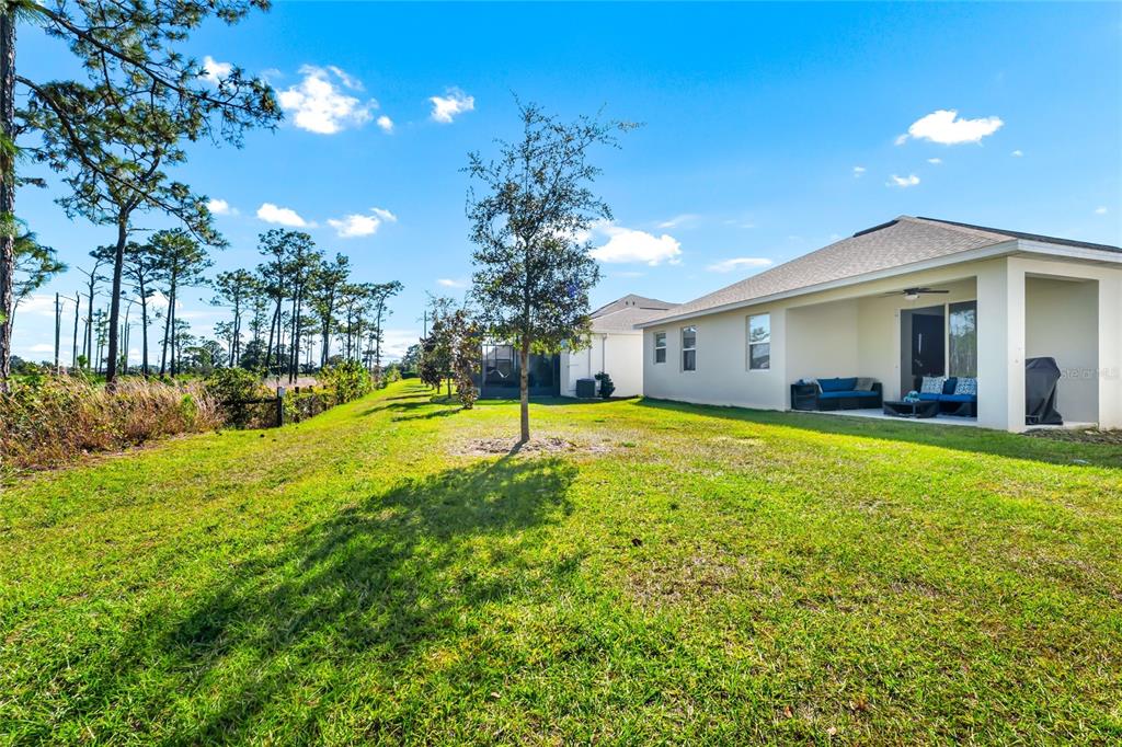 5656 Quiet Palm Loop St. Cloud, FL 34771 - Photo 30 of 36 a swimming pool with outdoor seating and yard
