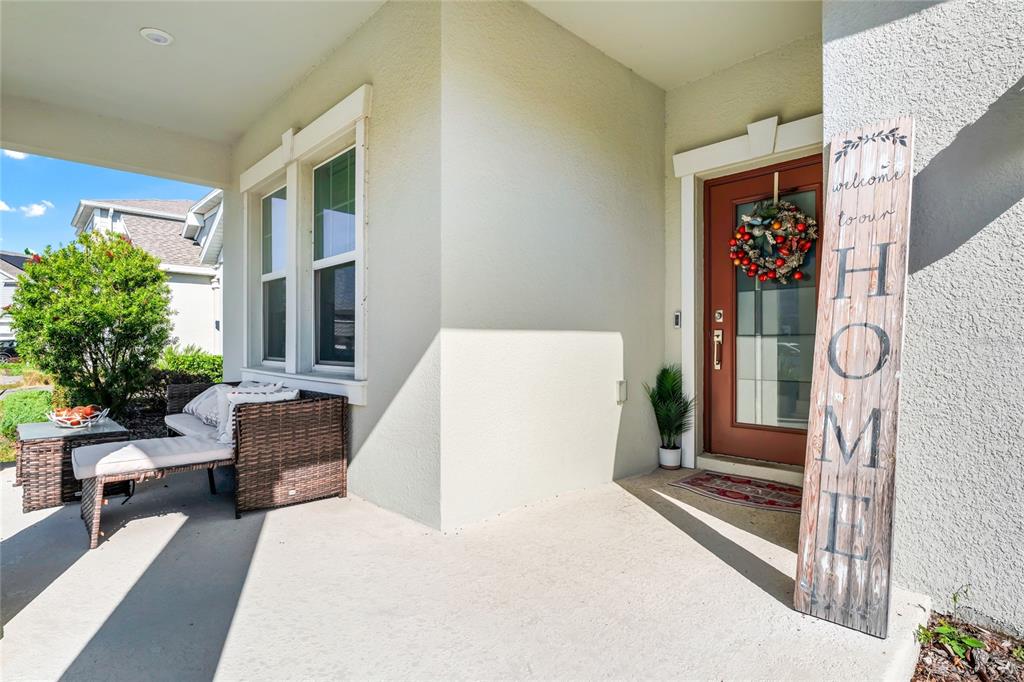 5656 Quiet Palm Loop St. Cloud, FL 34771 - Photo 3 of 36 a living room with furniture and a gate