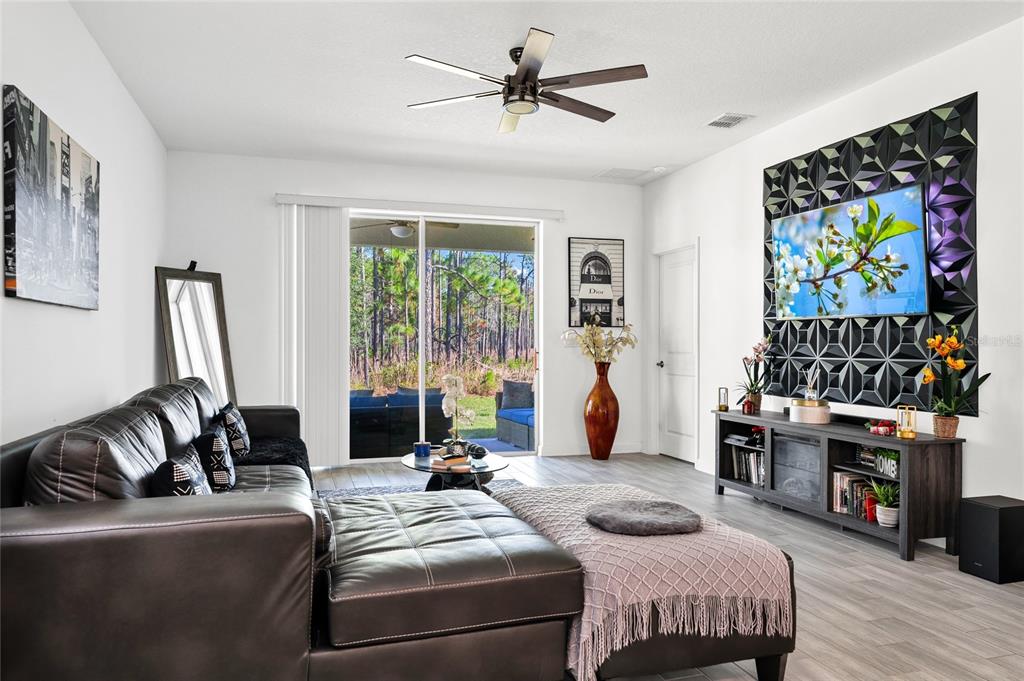 5656 Quiet Palm Loop St. Cloud, FL 34771 - Photo 7 of 36 a bedroom with a bed and a flat screen tv